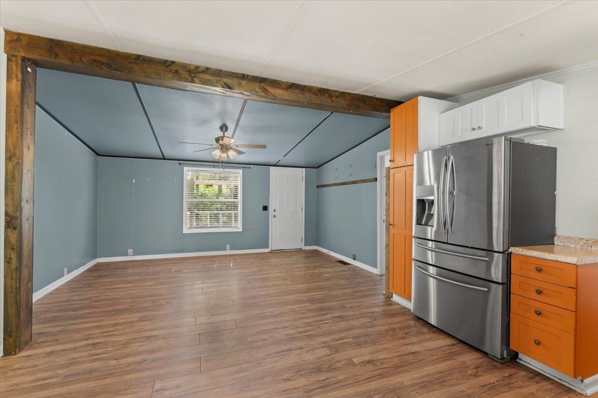 6860 Catlett Road St. Augustine, FL 32095 - Photo 7 of 36 Kitchen featuring stainless steel refrigerator with ice dispenser, dark wood-style floors, light countertops, beam ceiling, and a ceiling fan