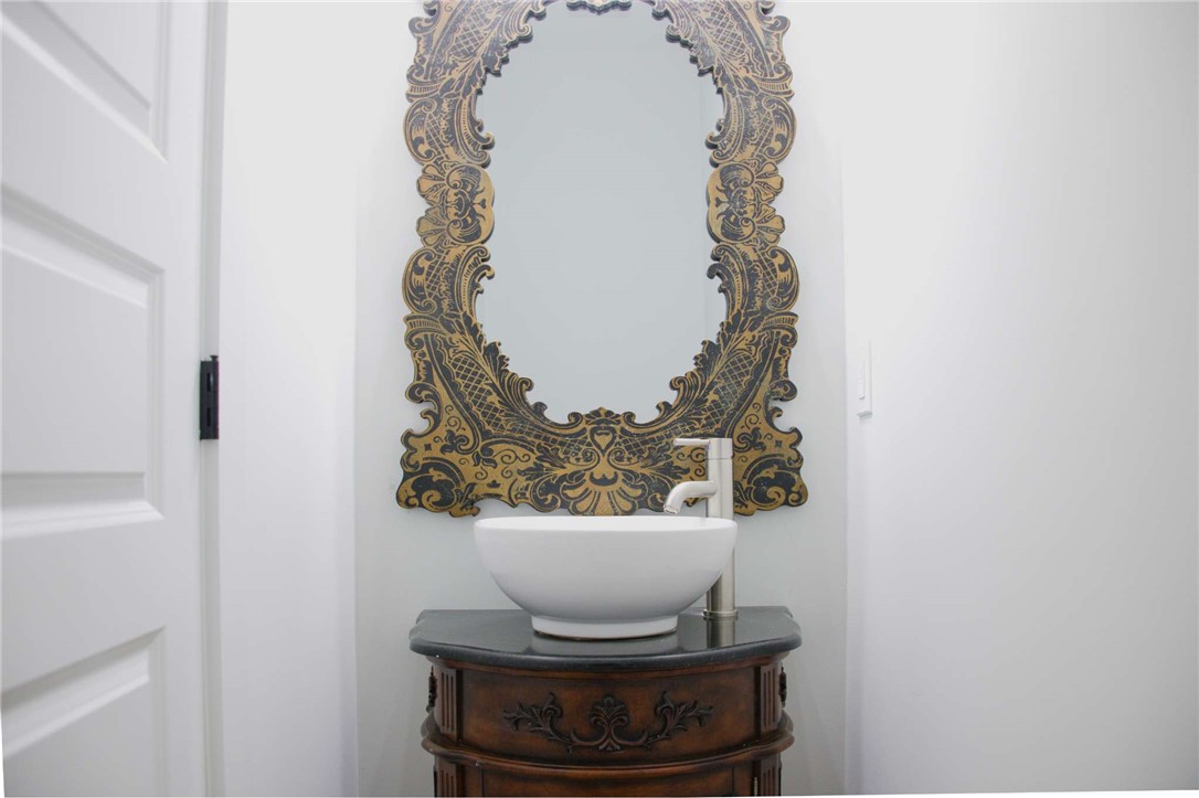 2515 Highway 29 Anderson, SC 29621 - Photo 19 of 38 A unique vessel sink vanity and ornate mirror offer a touch of classic luxury.