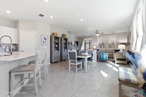 a living room with furniture a dining table and kitchen view