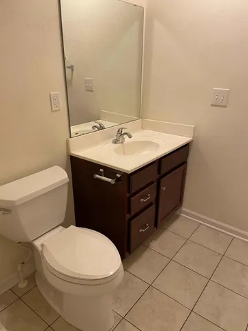 a bathroom with a sink vanity and toilet