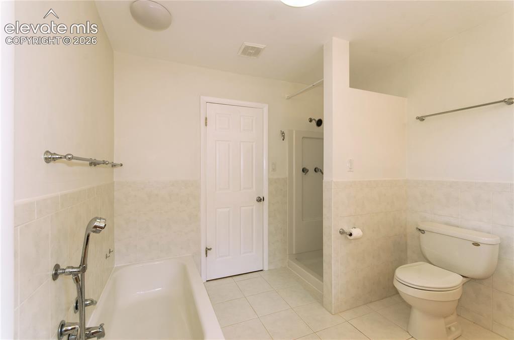 4710 Limestone Road Monument, CO 80132 - Photo 32 of 50 a bathroom with a granite countertop sink a toilet and shower