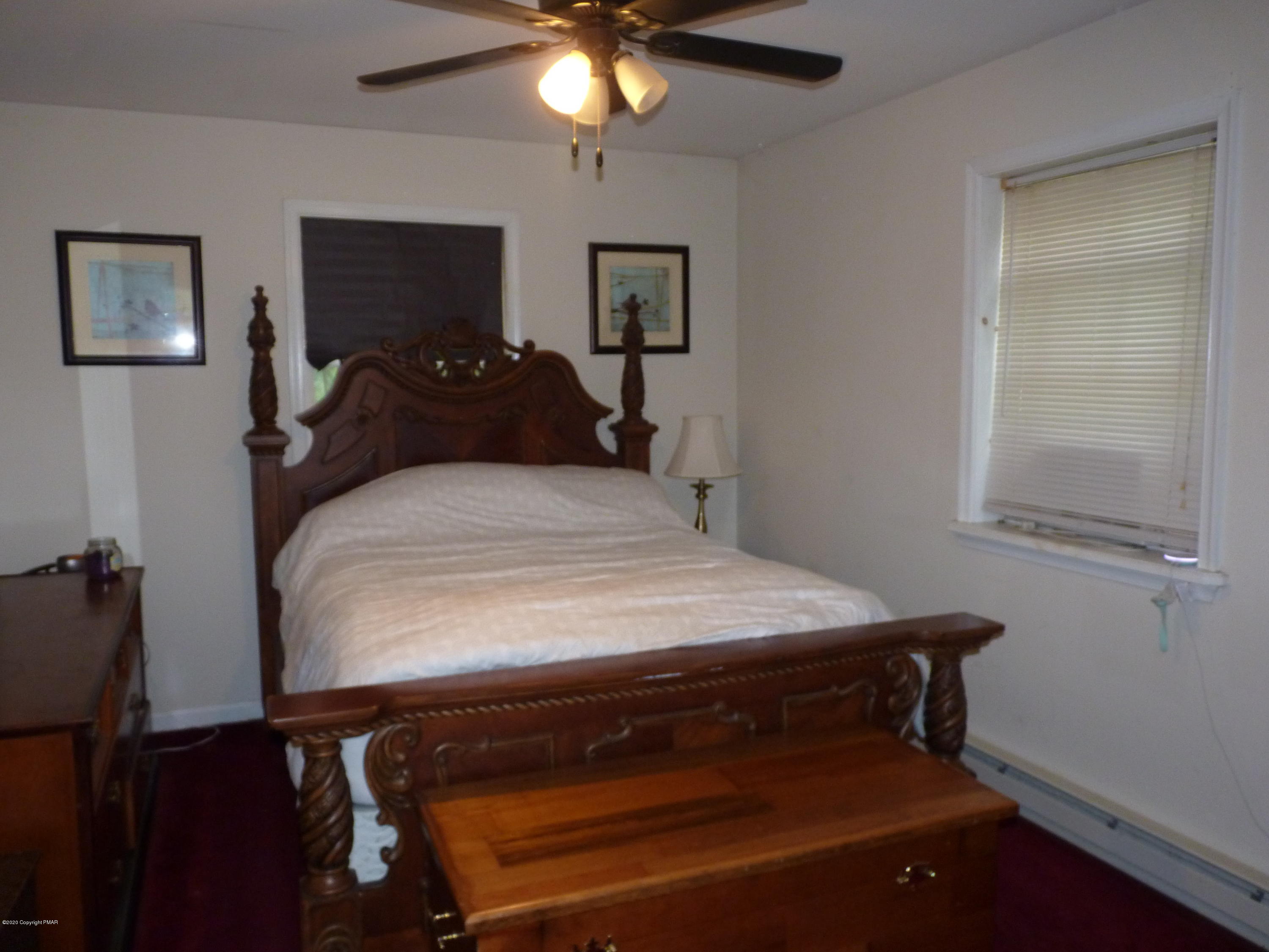 139 Fern Ridge Road Blakeslee, PA 18610 - Photo 11 of 19 a bed sitting in a bedroom next to a window