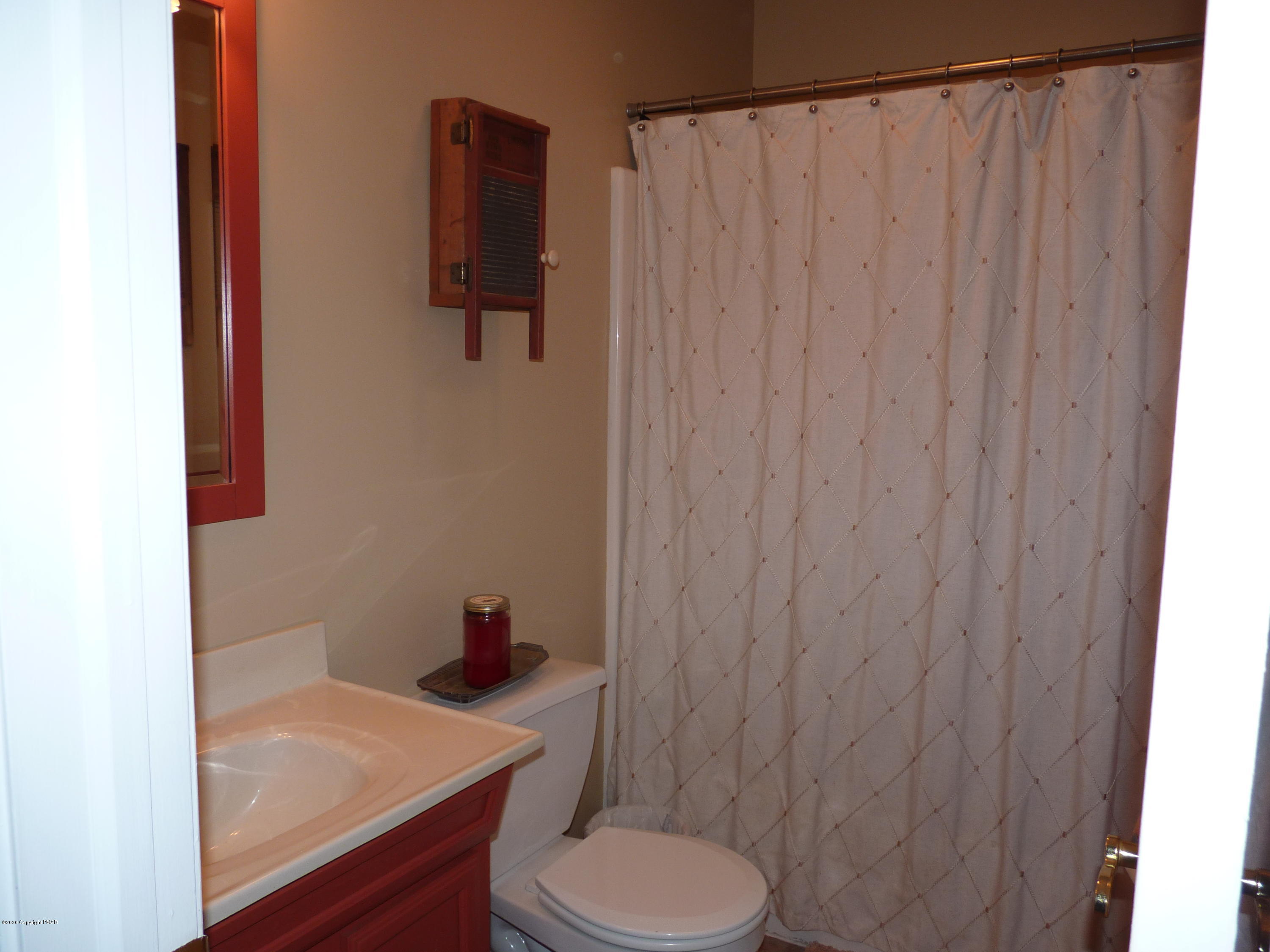 139 Fern Ridge Road Blakeslee, PA 18610 - Photo 15 of 19 a bathroom with a toilet and a sink