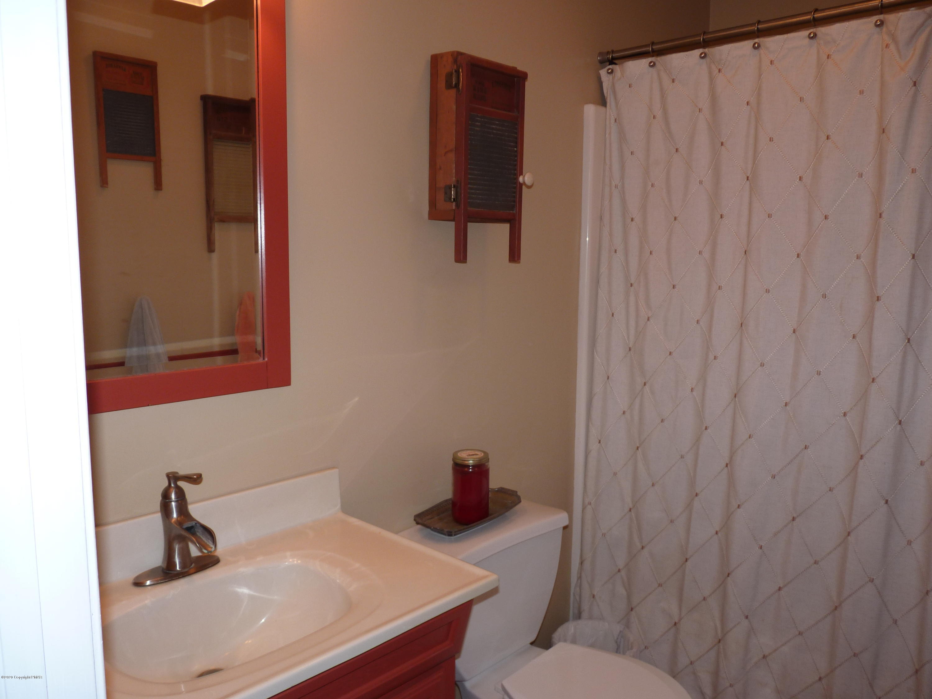 139 Fern Ridge Road Blakeslee, PA 18610 - Photo 16 of 19 a bathroom with a sink and a toilet