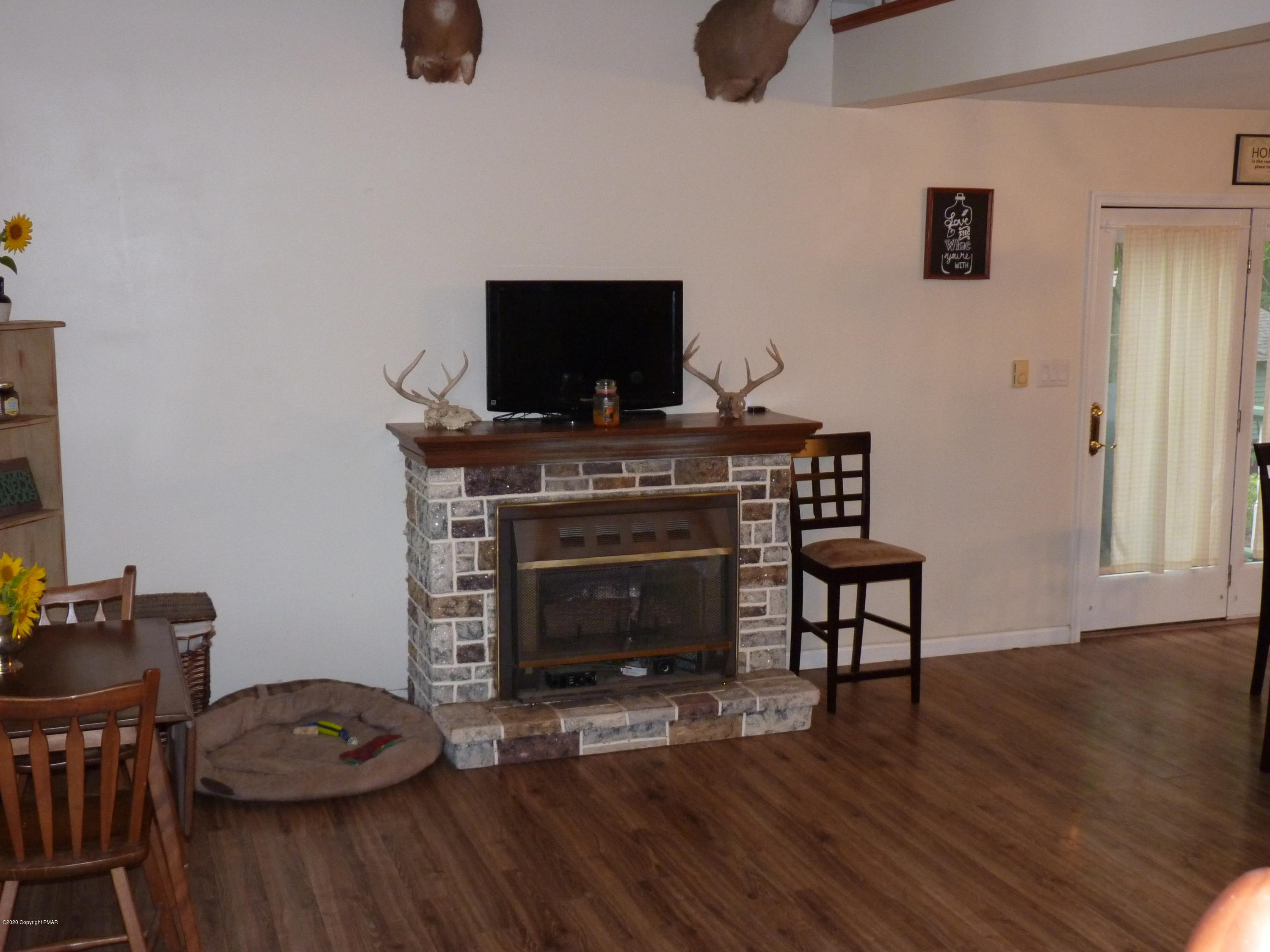 139 Fern Ridge Road Blakeslee, PA 18610 - Photo 3 of 19 a living room with furniture and a fireplace