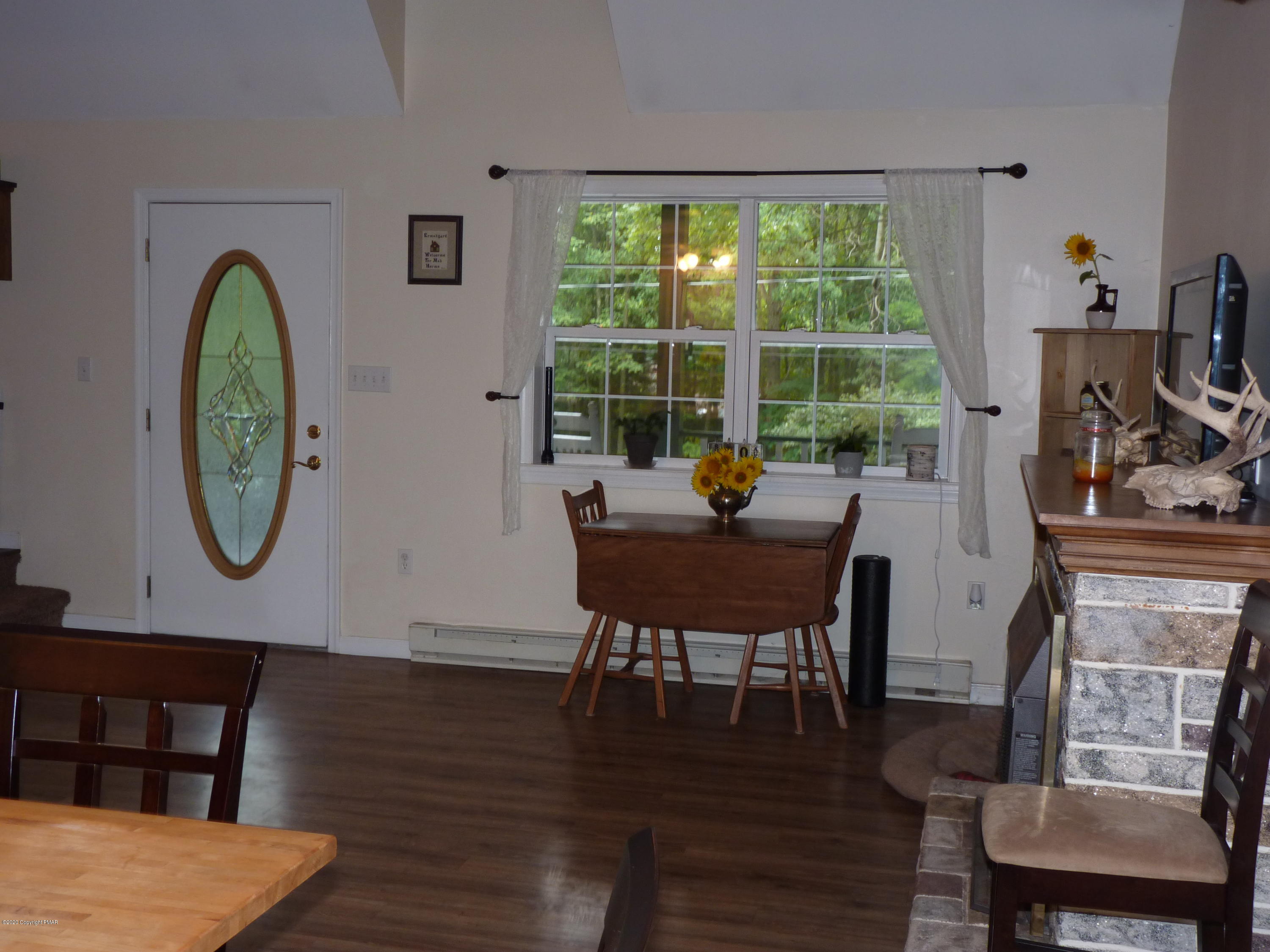 139 Fern Ridge Road Blakeslee, PA 18610 - Photo 5 of 19 a view of a dining room with furniture window and wooden floor