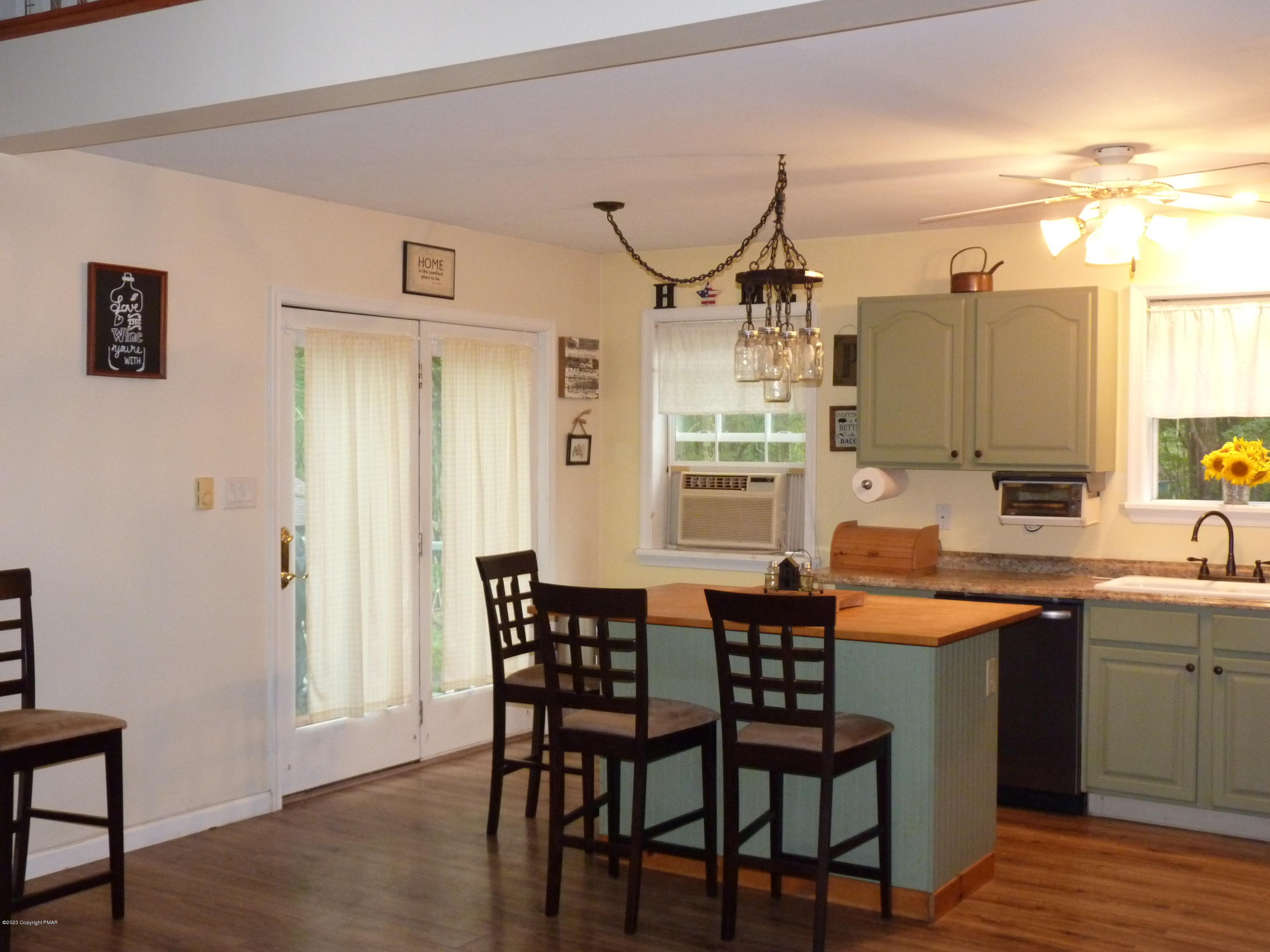 139 Fern Ridge Road Blakeslee, PA 18610 - Photo 6 of 19 a dining hall with stainless steel appliances a table and chairs