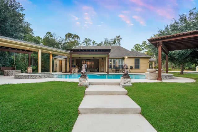 a front view of a house with yard and green space