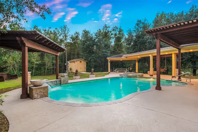 a view of swimming pool with sitting area