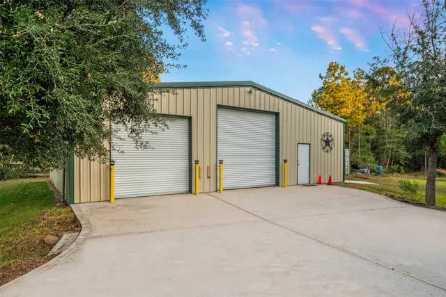 a view of a house with a garage and yard