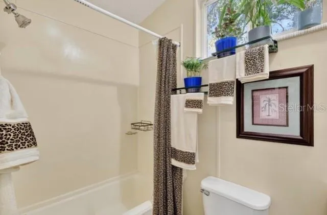 a bathroom with a toilet and shower