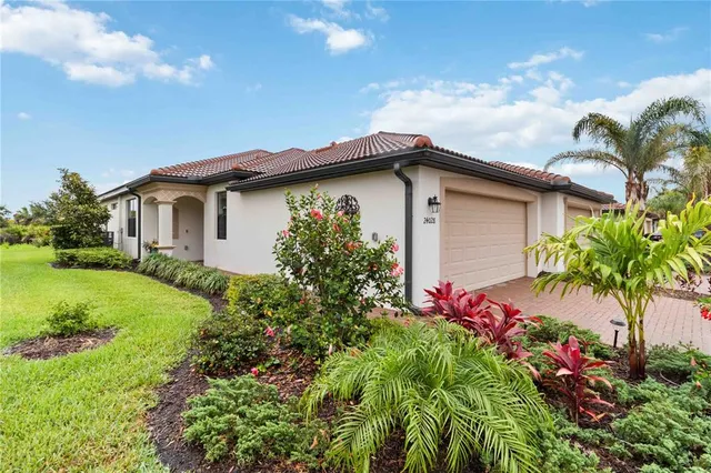 a white house with a yard and potted plants