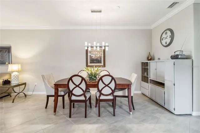 a view of a dining room and livingroom with furniture wooden floor a rug and a painting