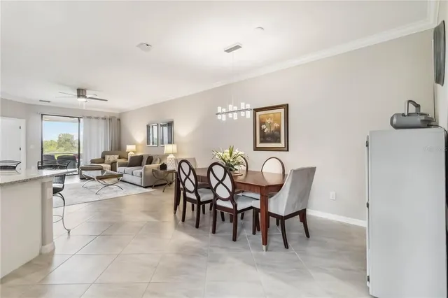 a view of a dining room with furniture and a chandelier