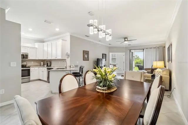 a kitchen with granite countertop white cabinets and stainless steel appliances
