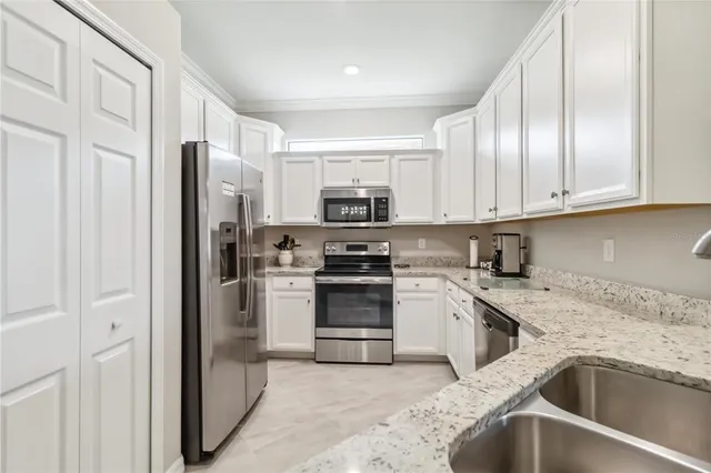 a kitchen with a refrigerator and a sink