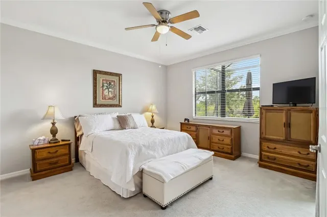 a bedroom with bed and a chandelier
