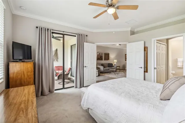a living room with furniture a desk and a flat screen tv