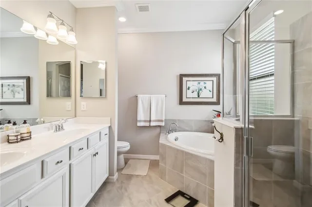 a view of a hallway with closet and a bathroom