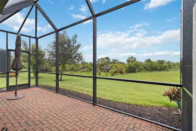 an aerial view of residential houses with outdoor space and river