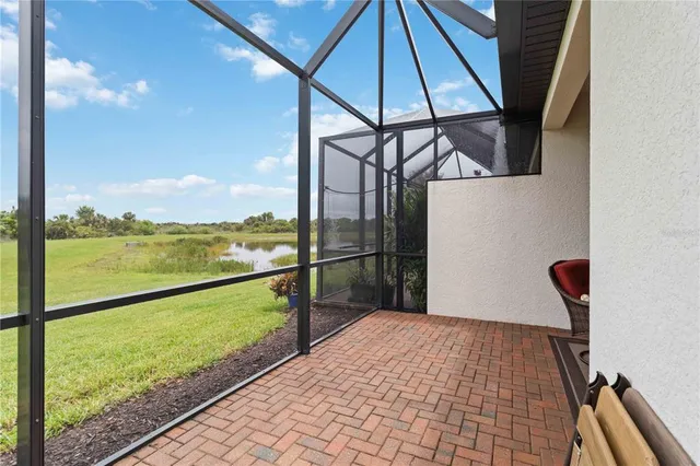 a view of a house with a yard and potted plants