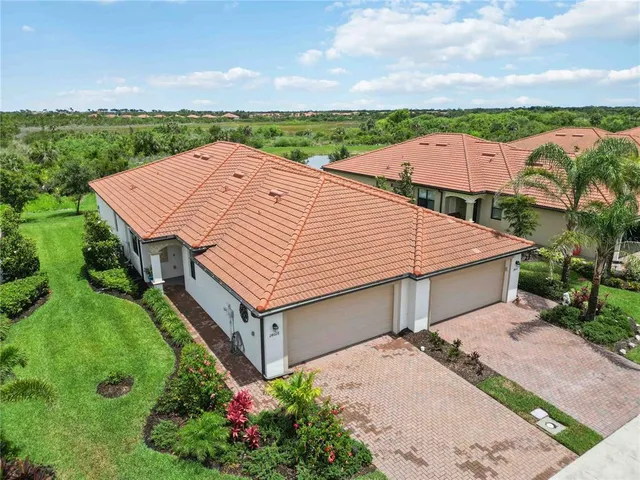 an aerial view of residential houses with outdoor space
