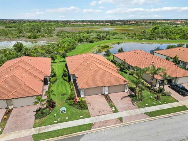 an aerial view of residential houses with outdoor space