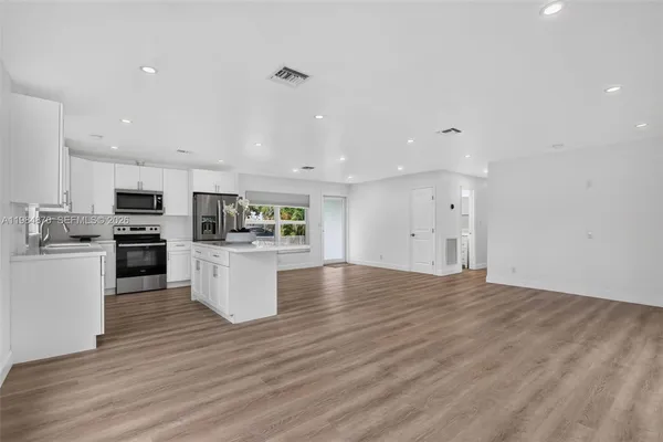 a kitchen with stainless steel appliances a refrigerator stove and microwave