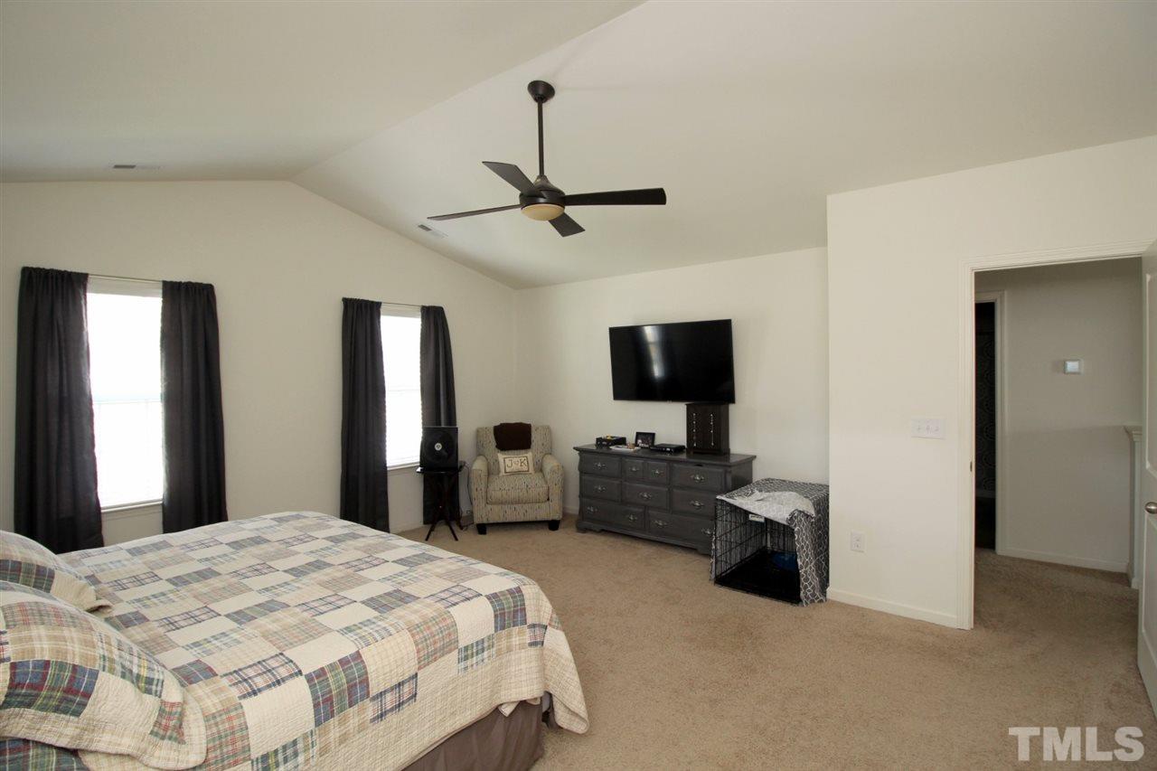 3600 Marble Ridge Lane Raleigh, NC 27610 - Photo 12 of 23 a bedroom with a bed and a flat screen tv