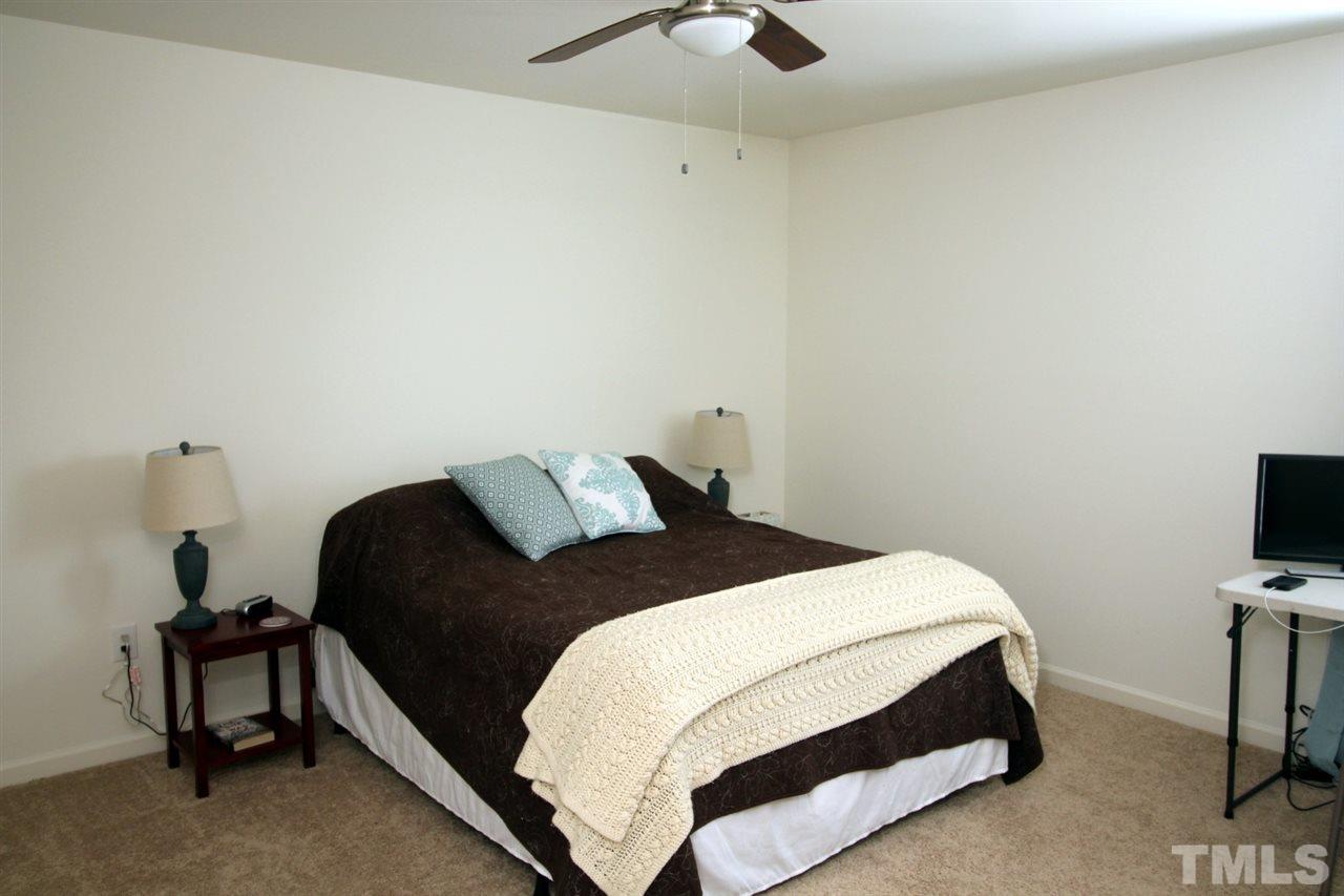 3600 Marble Ridge Lane Raleigh, NC 27610 - Photo 13 of 23 a bedroom with a bed and a flat tv screen on a dresser