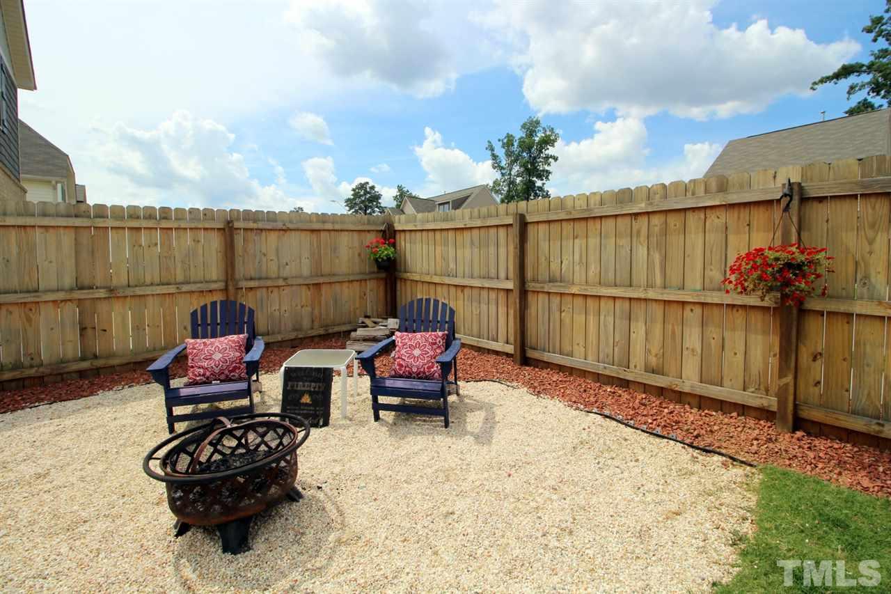 3600 Marble Ridge Lane Raleigh, NC 27610 - Photo 20 of 23 a backyard of a house with barbeque oven table and chairs