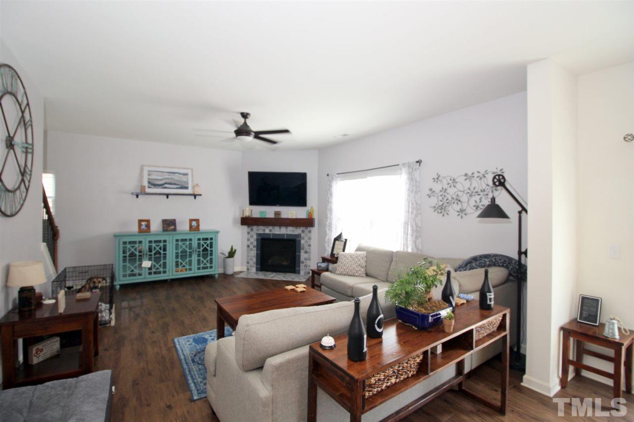 3600 Marble Ridge Lane Raleigh, NC 27610 - Photo 7 of 23 a living room with furniture a fireplace and a flat screen tv