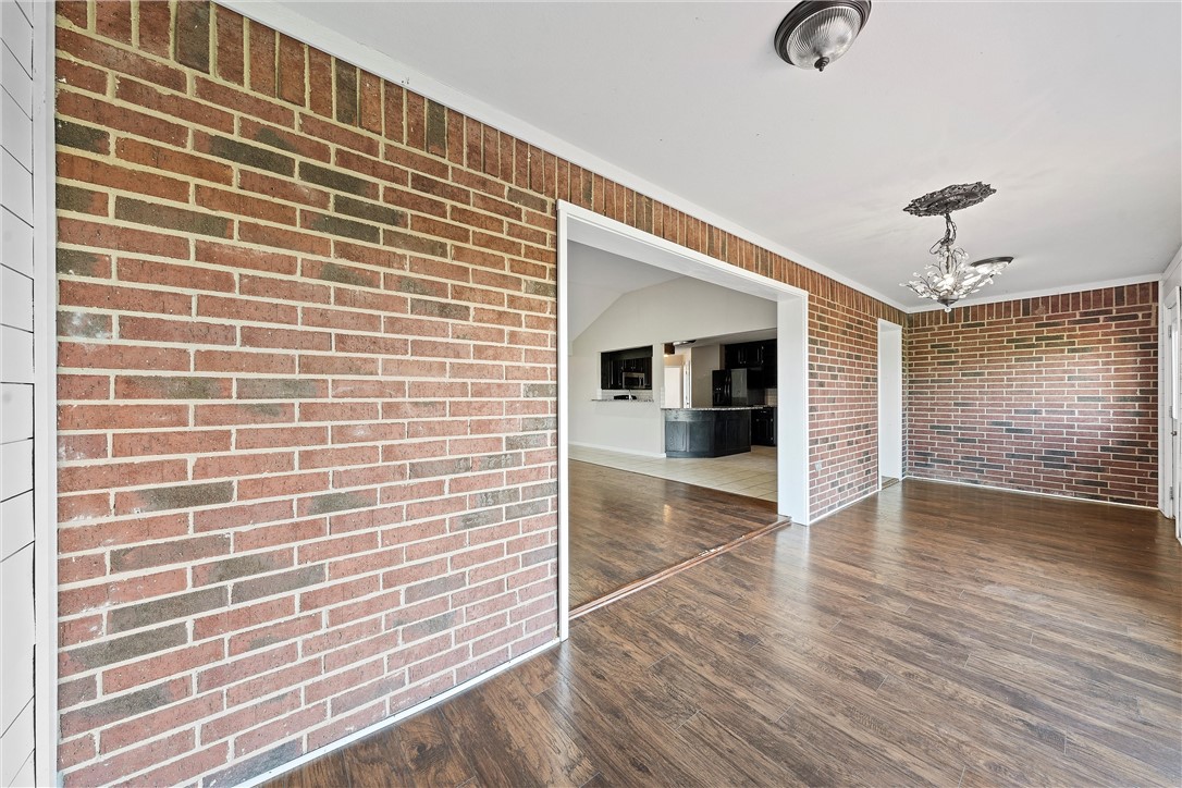 1312 North Rock Creek Road Waco, TX 76708 - Photo 12 of 46 a view of a hallway with wooden floor and a flat screen tv