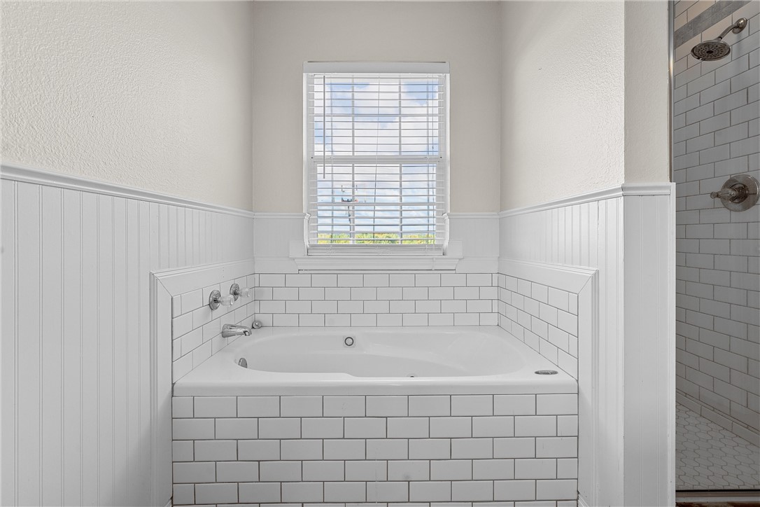 1312 North Rock Creek Road Waco, TX 76708 - Photo 20 of 46 a white bath tub sitting next to a window