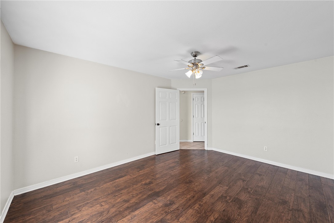 1312 North Rock Creek Road Waco, TX 76708 - Photo 22 of 46 a view of an empty room with a chandelier fan