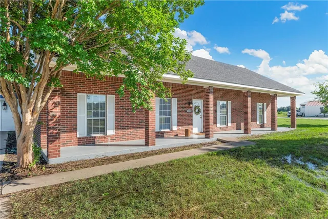 a kitchen with stainless steel appliances a stove microwave and sink