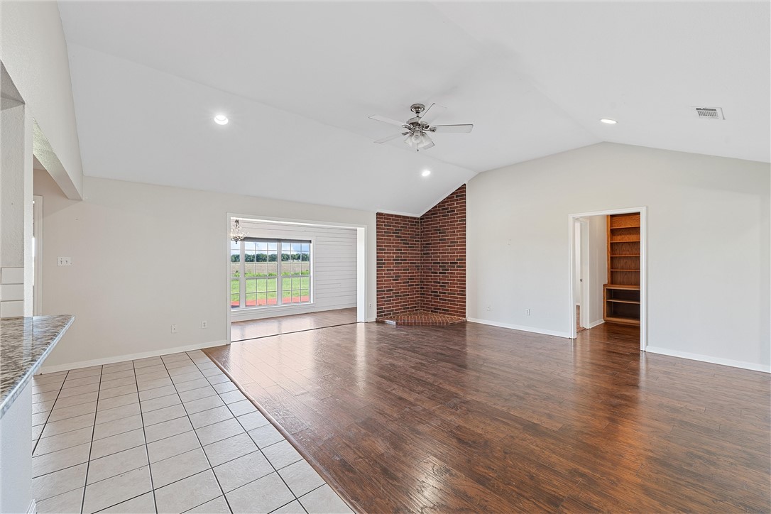 1312 North Rock Creek Road Waco, TX 76708 - Photo 6 of 46 wooden floor in an empty room with a window