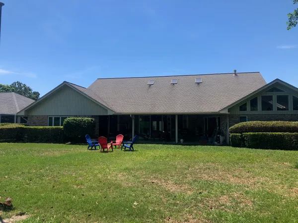 a view of a house with a yard and sitting area