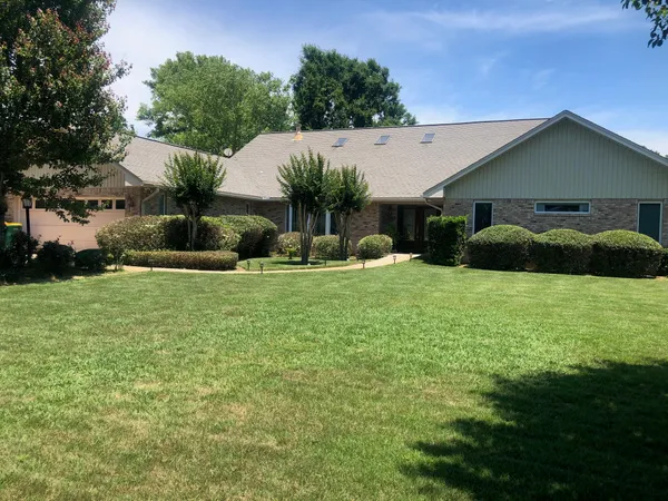 a front view of a house with garden