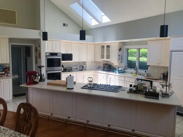 a kitchen with a stove a sink and a microwave