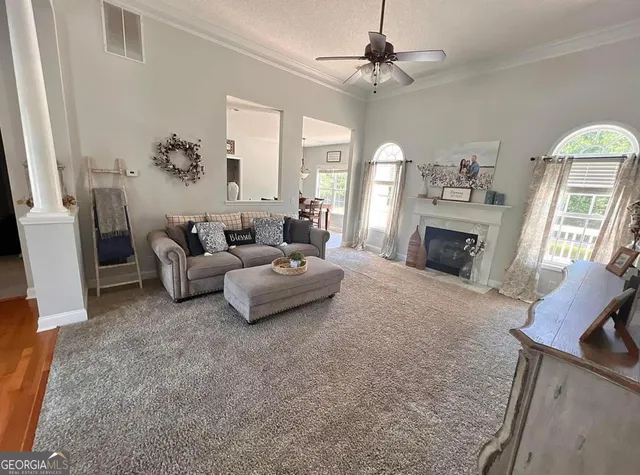 a living room with furniture and a fireplace
