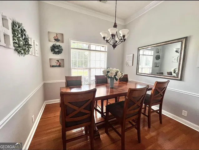 a dining room with furniture a rug and wooden floor