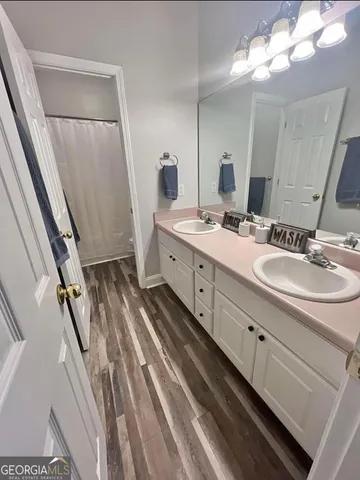 a bathroom with a double vanity sink and mirror