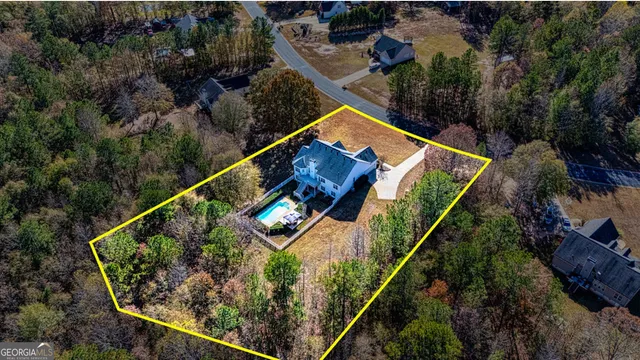 an aerial view of a house with a swimming pool