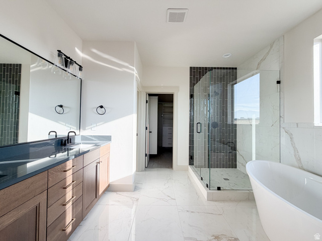 533 West S Temple Street, Unit 309 Tooele, UT 84074 - Photo 11 of 24 Bathroom with a shower stall, a soaking tub, a walk in closet, double vanity, and light marble finish floors