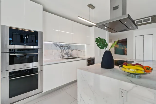 a kitchen with a refrigerator and a stove