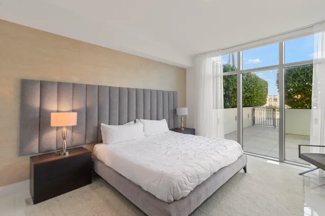 a bedroom with a bed and a lamp