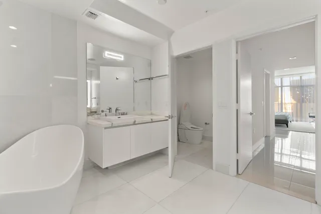 a bathroom with a bathtub a sink and a mirror