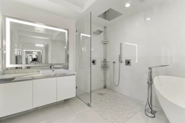a bathroom with a double vanity sink toilet and shower