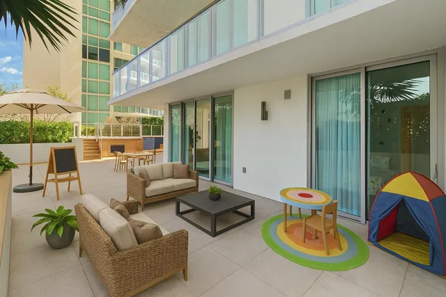 a view of a patio with couches and a potted plant on a table